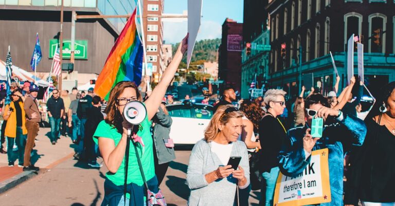 A vibrant protest with diverse participants holding flags and signs on a city street.