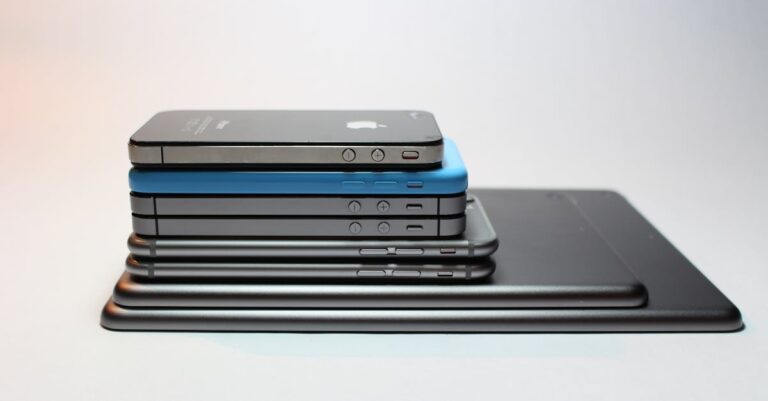 Stacked modern smartphones and tablets showcasing sleek design. Perfect tech background.