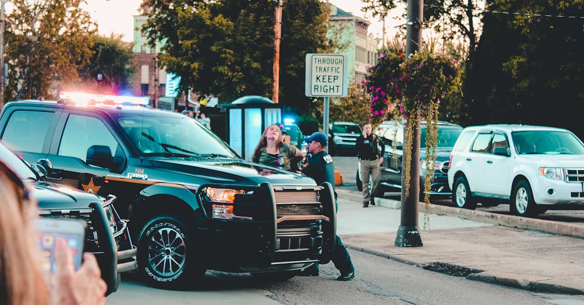 Police officers and vehicles on a busy city street, Wheeling, WV in daylight.