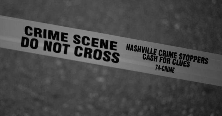 Black and white close-up of crime scene tape with Nashville text.