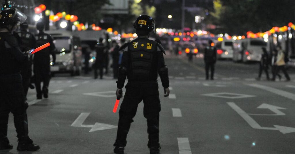 Police officers maintaining order during a night street patrol, ensuring public safety.
