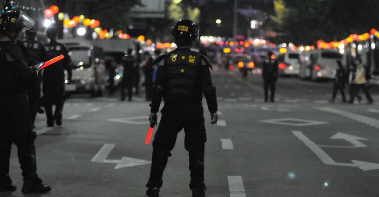 Police officers maintaining order during a night street patrol, ensuring public safety.