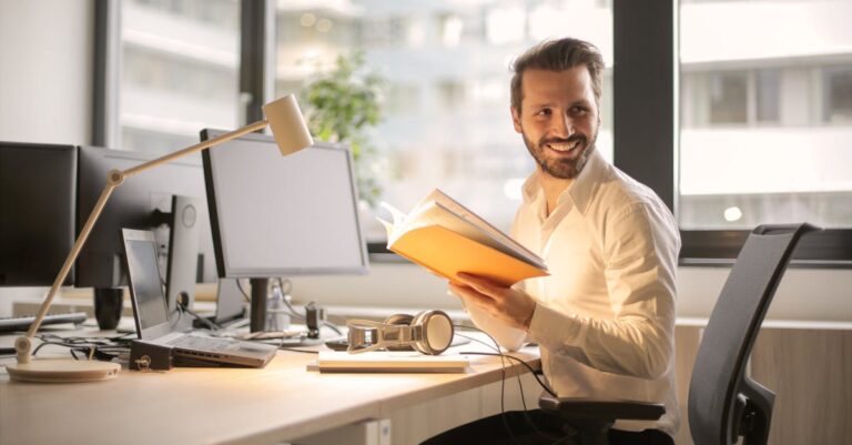 A relaxed businessman enjoying a break in his bright, contemporary office environment.