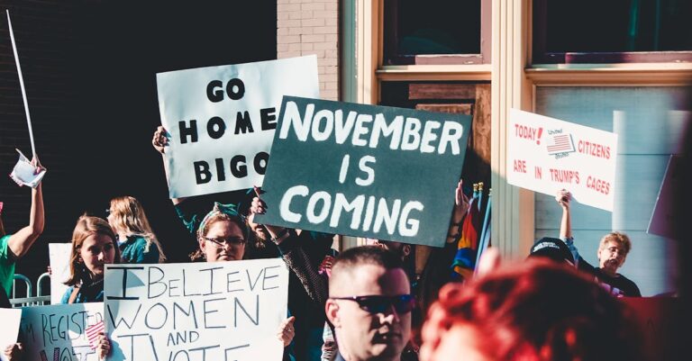 Dynamic street protest with diverse group holding impactful signs.