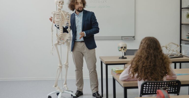 Teacher explaining anatomy with skeleton model in bright classroom setting.