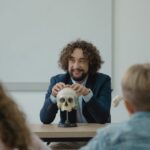 Teacher engaging students with a skull model in an interactive biology lesson.