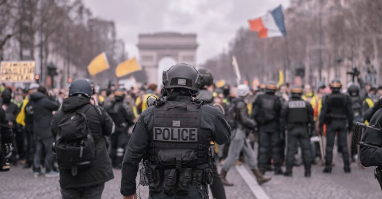 Demonstrators and police face off during a protest in Paris, near the Arc de Triomphe.