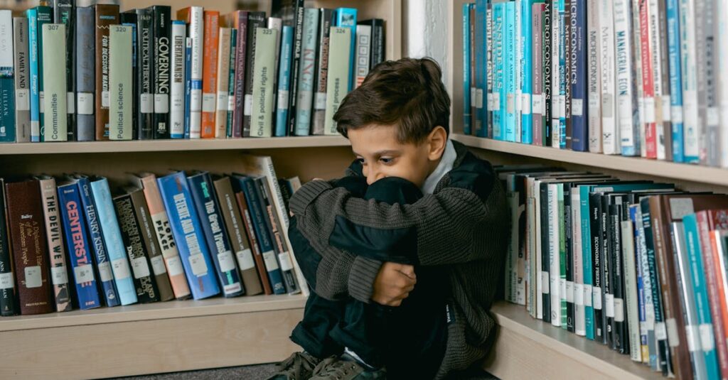 Young boy in library appears sad, sitting alone among bookshelves, suggesting themes of solitude and bullying.