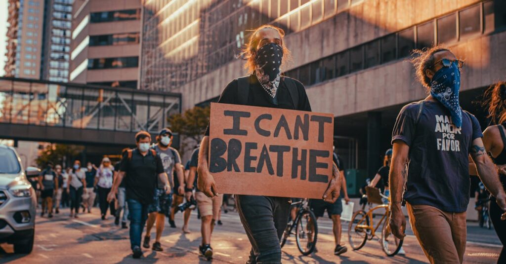 People protesting against racial injustice in Minneapolis, holding signs like 'I Can't Breathe'.
