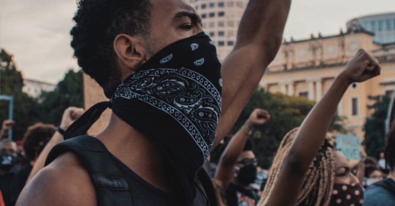 A powerful demonstration in Rio de Janeiro with protesters passionately raising their fists in unity.