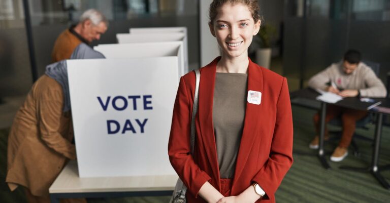 Woman in red suit at voting station, promoting civic engagement on election day.