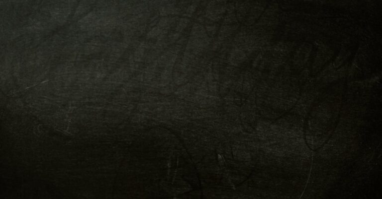A textured dark chalkboard background, perfect for design projects.