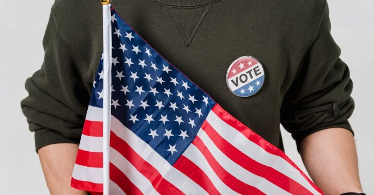A person holding an American flag with a vote badge, symbolizing patriotism and democracy.