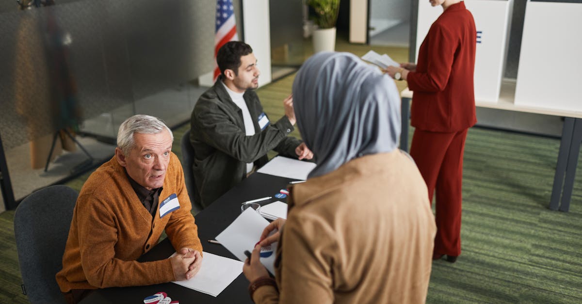Adults engaging in the voting process at an indoor polling station, representing diverse backgrounds and social responsibility.