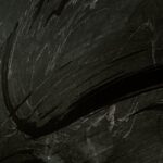 Intriguing black chalkboard with expressive chalk smudges, ideal for backgrounds or textures.