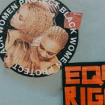 A mural advocating for black women's rights alongside a bold 'Equal Rights' sign.