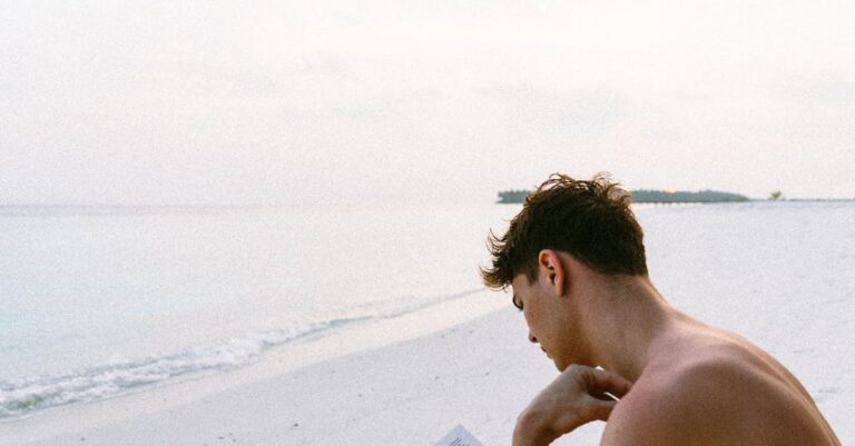A man enjoys reading a book on a serene Maldives beach, capturing the essence of relaxation.