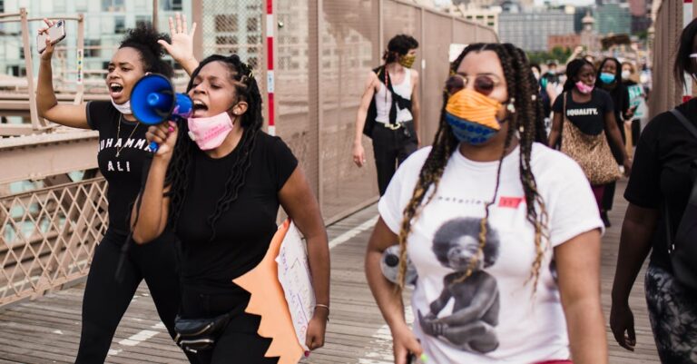 Group of diverse people gathered for a Black Lives Matter protest outdoors in the city.