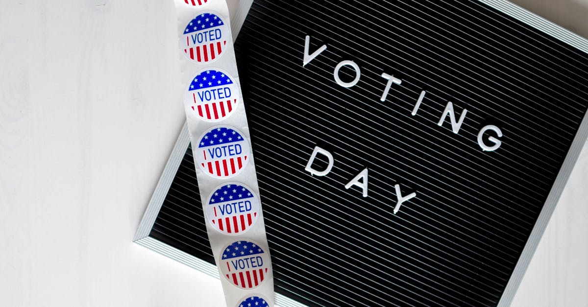 Close-up of a Voting Day sign and roll of I Voted stickers.