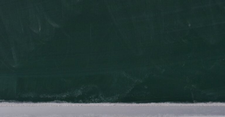 A dusty blackboard with chalk pieces, ideal for educational themes.