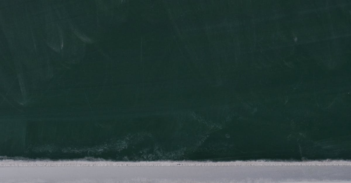 A dusty blackboard with chalk pieces, ideal for educational themes.