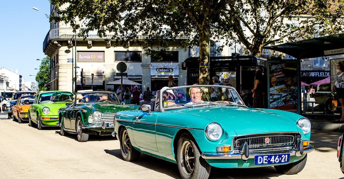 A vibrant scene of classic cars parading in Périgueux, capturing nostalgic charm.