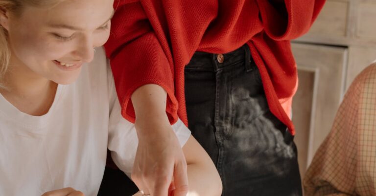 Two college students collaborate on homework, discussing and solving problems with books and notes.