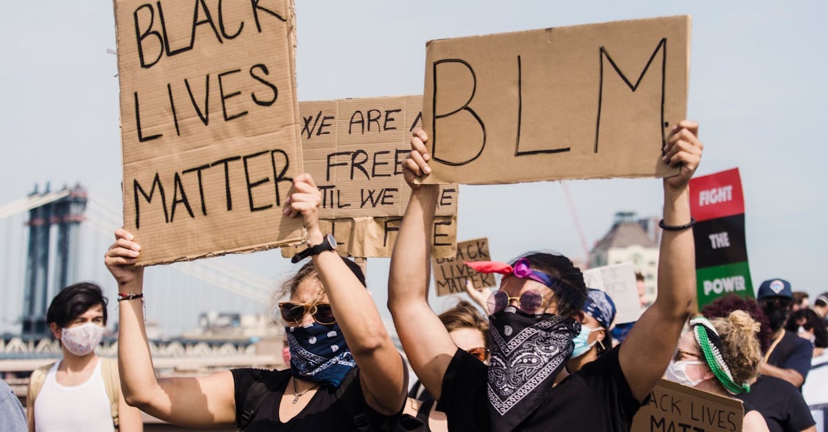 Protestors holding signs at a Black Lives Matter demonstration advocating for justice and equality.