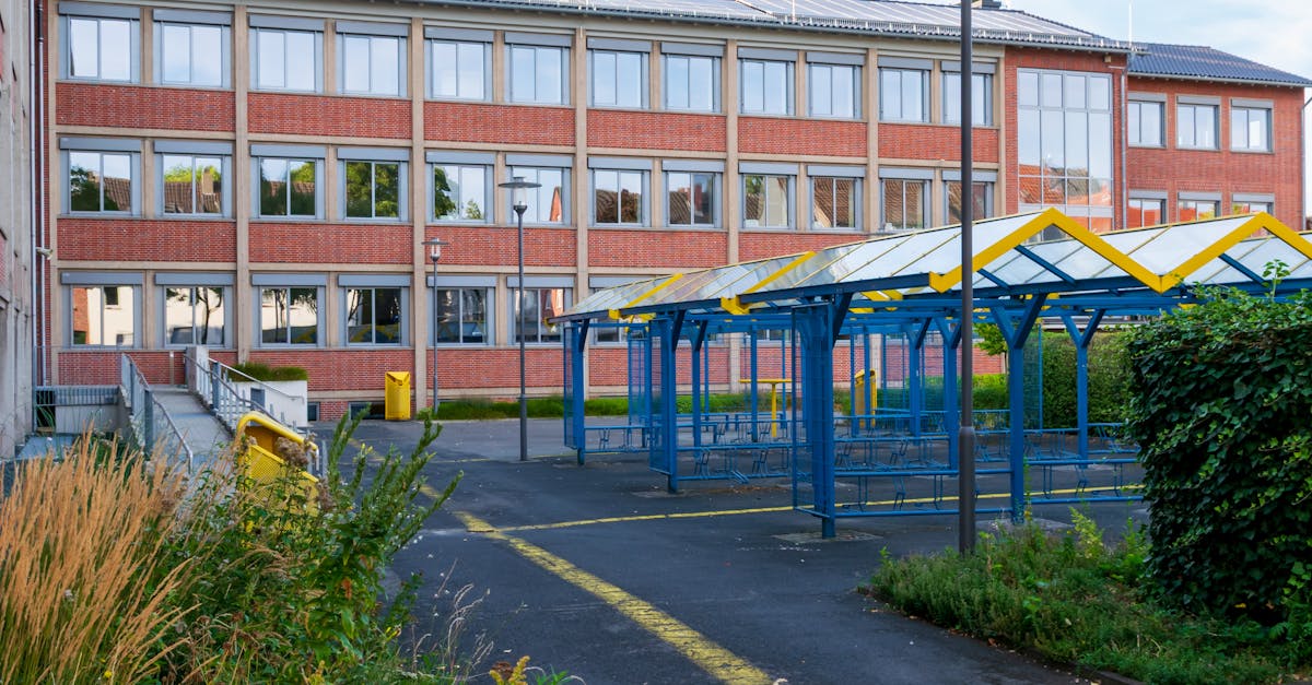 A contemporary school building with colorful playground structures on a sunny day.
