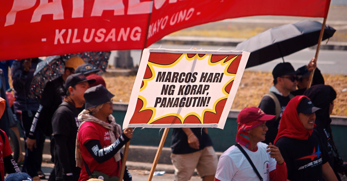 People marching with banners in a protest in the Philippines highlighting a political message.