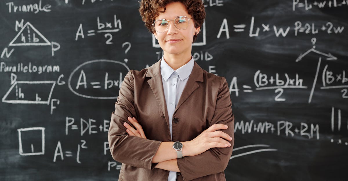 Confident female teacher standing with arms crossed in front of a detailed mathematical blackboard.