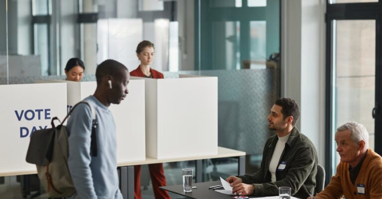 People participating in voting at an indoor election office with diverse representation.