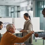 People of various backgrounds participating in voting at a polling station.