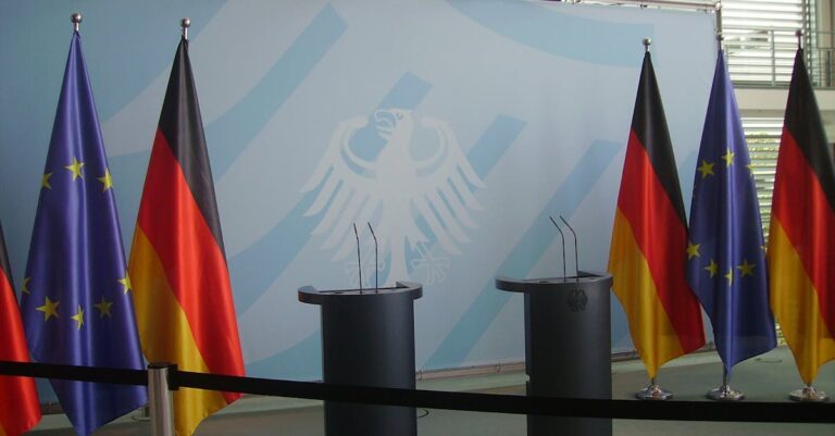 Empty podiums with German and EU flags in Federal Chancellery, Berlin.