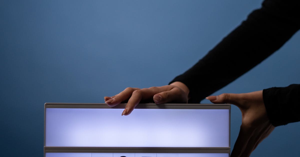 Close-up of hands placing a lit vote sign with a bold message on a blue background.