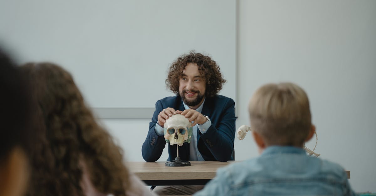 Teacher engaging students with a skull model in an interactive biology lesson.