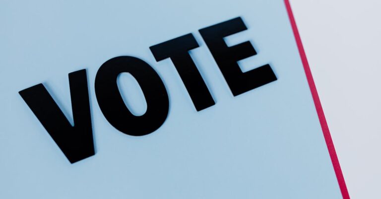 Close-up of the word 'VOTE' on a minimal background, emphasizing voting importance.
